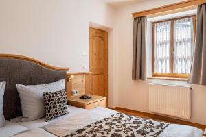a bedroom with a bed and a window at Schreiberhof Panorama in Laion