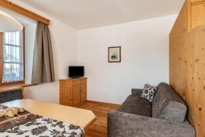 a living room with a couch and a table at Schreiberhof Panorama in Laion