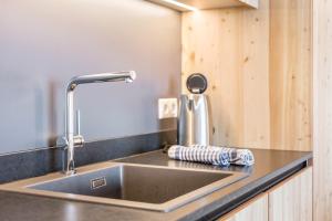 a kitchen sink with a faucet on a counter at Aura Chalets - Nr 1 in Castelrotto +26 photos
