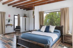 a bedroom with a bed and a large window at Guenia ll in El Mojón