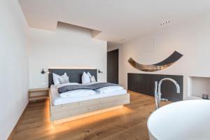 a bedroom with a bed and a sink at Aura Chalets - Nr 1 in Castelrotto