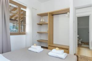 a bedroom with a bed with towels on it at Peter's Paradise in Telendos +23 photos