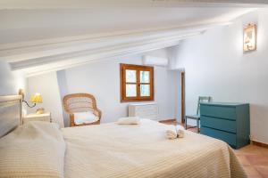 a bedroom with a large bed and a blue dresser at Casa Caimari in Caimari +18 photos