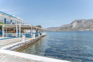 a restaurant on the shore of a body of water at Peter's Paradise in Telendos