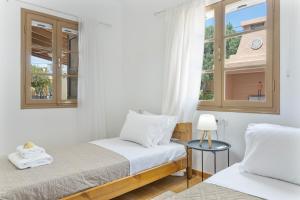 a bedroom with two beds and a window at Peter's Paradise in Telendos