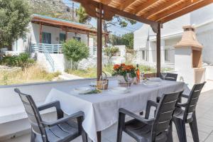 a table with a white table cloth on a patio at Peter's Paradise in Telendos