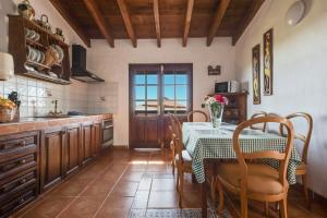 a kitchen with a table and a table and chairs at La Cuadra de Arona in Arona