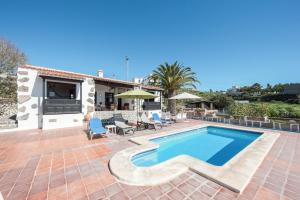 a villa with a swimming pool and a patio at La Cuadra de Arona in Arona