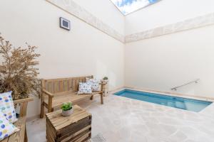 a living room with a swimming pool in a house at Es Campanar in Santanyi
