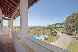 a view from the balcony of a house with a swimming pool at Melquites Country House in Barrantes