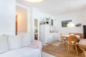 a living room with a couch and a dining room at Voglsang - Haus Annamirl in Bayrischzell