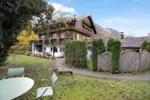 a house with a fence in front of a yard at Voglsang - Haus Annamirl in Bayrischzell