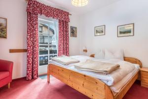 a bedroom with a bed and a window at Voglsang - Haus Annamirl in Bayrischzell