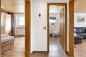 a hallway with a door leading to a living room at Haus Fritz in Wittenschwand +26 photos