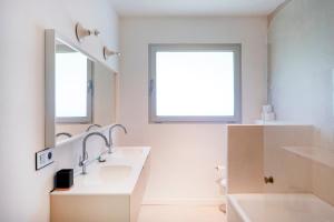 a bathroom with two sinks and a mirror at Villa Piscine Entre Lac et Océan in Soorts-Hossegor +23 photos
