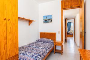 a small bedroom with a bed and a table at Can Vidal Cabrera in Ses Salines