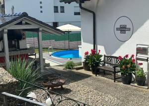 a patio with a bench and a swimming pool at Ferienwohnung Felsenblick in Albstadt