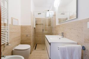 a bathroom with a toilet and a sink and a shower at Andromeda's Rooms in Otranto