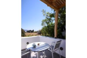 a table and chairs on the balcony of a house at Echinousa Kimolos katoikia no6 in Kimolos +9 photos