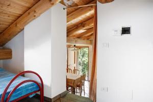 a bedroom with a bed and a balcony with a table at Anemone Tano di Grich in Cesani