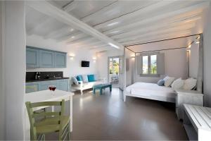 a living room with a bed and a kitchen at Echinousa Kimolos katoikia no6 in Kimolos