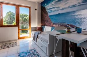 a living room with a couch and a table at Mono Le Lecce 38b in Capoliveri