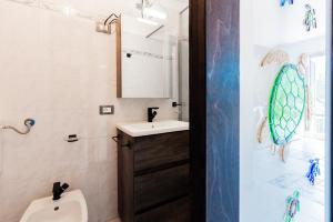 a bathroom with a sink and a toilet and a mirror at Mono Le Lecce 38b in Capoliveri +12 photos
