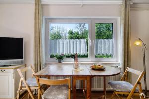 a dining room with a table and a window at Ferienwohnung Zizi in Stockach +17 photos