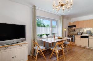 a kitchen with a table with chairs and a television at Ferienwohnung Zizi in Stockach