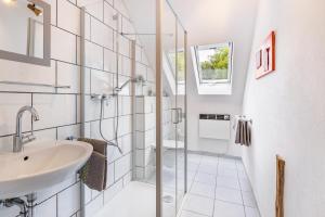 a bathroom with a sink and a shower at Ferienhaus Mülhaupt in Ühlingen-Birkendorf +43 photos
