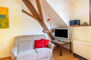 a living room with a couch and a tv at Ferienhaus Mülhaupt in Ühlingen-Birkendorf