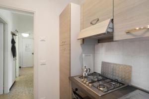 a kitchen with a stove top oven next to a hallway at Alassio Mare E Non Solo 2 in Alassio