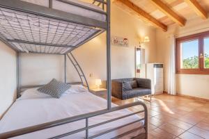 a bedroom with a bunk bed and a chair at Can Siurell in Artá +17 photos