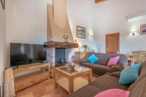 a living room with a large flat screen tv at Can Siurell in Artá
