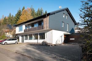 a house with a car parked in front of it at Waldglück Apartment in Feldberg