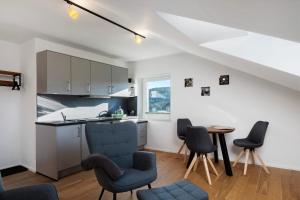 a kitchen with chairs and a table in a room at Waldglück Apartment in Feldberg
