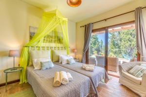 a bedroom with a bed with towels on it at Villa Faye in Gaios +22 photos