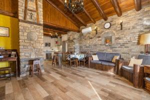 a large living room with a stone wall at Casa Perico in Borrastre