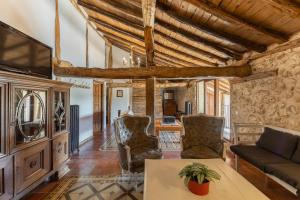 a living room with a couch and a table at La Botica De Maderuelo in Maderuelo
