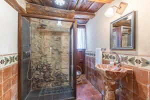 a bathroom with a shower and a sink at La Botica De Maderuelo in Maderuelo +28 photos