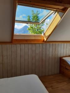 a skylight in a room with a bed and a window at studio Le Cabanon in Doussard