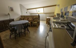 a kitchen and dining room with a table and a stove at studio Le Cabanon in Doussard +13 photos