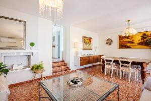 a living room with a table and a dining room at Casa Beramendi in Torremolinos