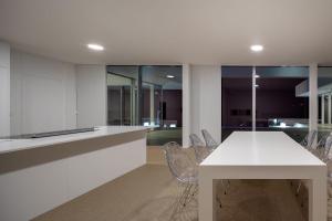 a kitchen with a white table and chairs at Villa Camacho - Ultra Luxury in Calheta