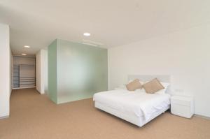 a bedroom with a white bed and a green wall at Villa Camacho - Ultra Luxury in Calheta +15 photos