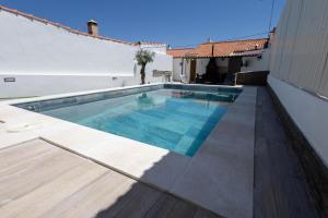 a swimming pool on the side of a house at Casa dos Avós in Santa Eulália