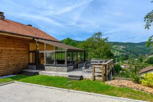 a house with a deck with a view at Chalet le Brusyna avec jacuzzi in Saint-Maurice-sur-Moselle
