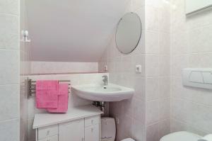 a white bathroom with a sink and a mirror at Bodenseeblick in Meersburg +8 photos