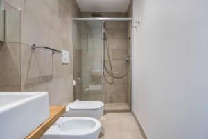 a bathroom with a shower and a toilet and a sink at Julia's Guesthouse in Auer +16 photos