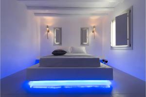 a bedroom with a bed with blue lights on it at Echinousa Kimolos Maisonette no1 in Kimolos
